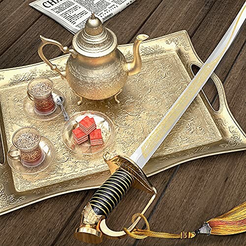 Ornate tea set on tray with sword on wooden table.